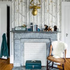 Eclectic Sitting Room Features a Patterned Accent Wall and a Marble and White Brick Fireplace