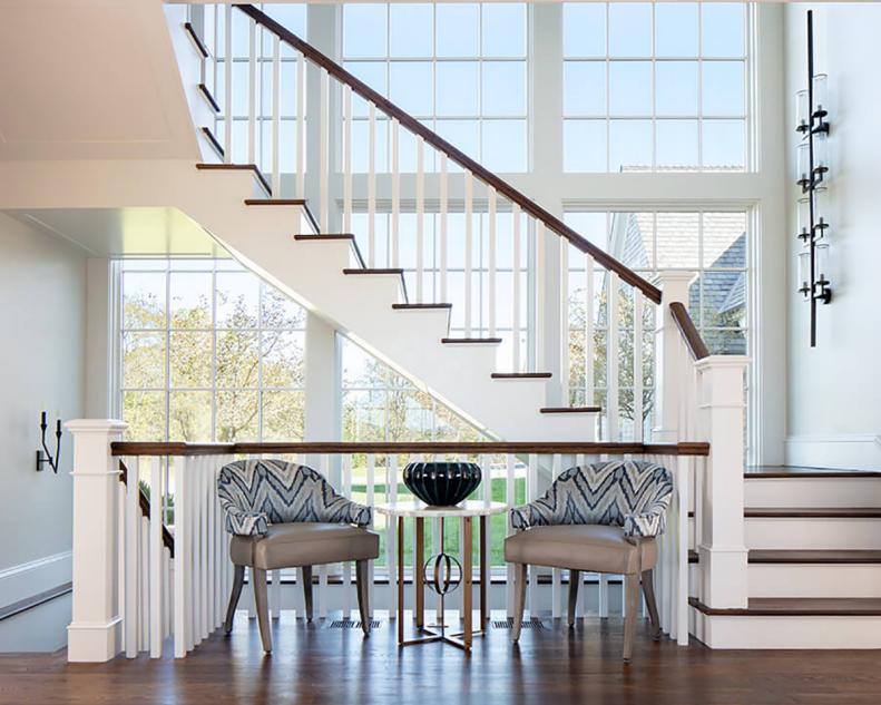 Bright Foyer With Floor-to-Ceiling Windows, Two Chairs, Sconce on Wall