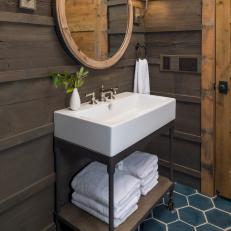 Powder Bath With Paneled Walls and Blue Hex Tile