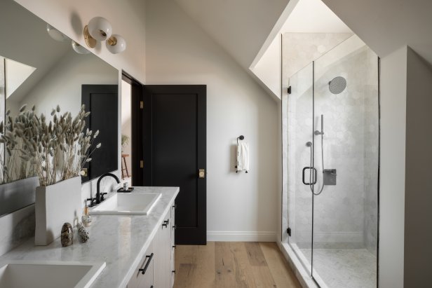 Careful placement of walls, doors, cabinetry and fixtures in the upstairs master bath made the best use of the space created by the angled ceilings upstairs.  A new dormer opened the room up with more space and light. 