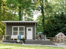 In order for the free-standing shed to fit seamlessly onto the property, it was situated afront a lush row of arborvitae and oak trees and privatized with a classic farmhouse style fence. A thick layer of gravel delineates the structure from the lush lawn and adjacent greenhouse.