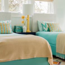 Blue and Orange Coastal Bedroom With Yellow Lamp