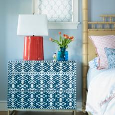 Patterned Dresser and Red Lamp