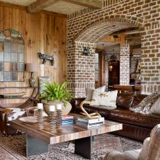 Rustic Basement With Brick Arches and Leather Sofa