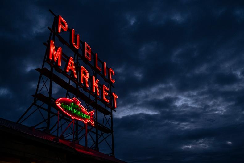 Glowing Pink Salmon and Red Public Market Script on Iconic Neon Sign