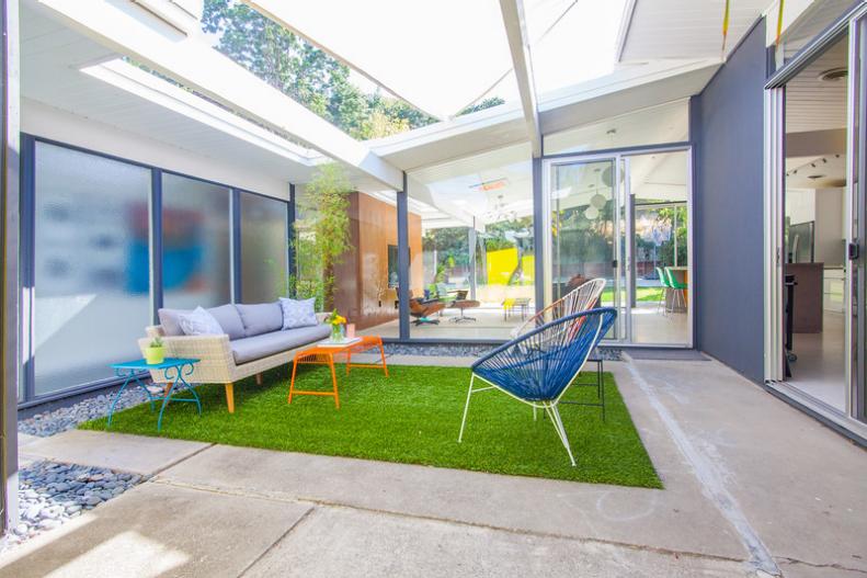 This midcentury modern home includes an atrium with grass.