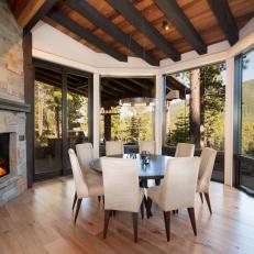 Rounded Rustic Dining Room With Fireplace