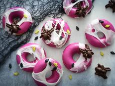 Serve up some creepy-crawly fun this Halloween with these purple candy-dipped doughnuts covered in marshmallow "webs." A spider candy mold is needed for this recipe and can be found at most well-stocked craft stores and online. You can also use ready-made gummy spiders for an easy shortcut.