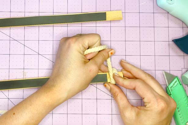 Wrap cord tightly and evenly at the end of the pine trim hanger before adhering with glue.