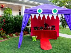 Be the coolest house on the block this Halloween by using dollar store scores to turn a pop-up canopy into a friendly monster that's stocked with grab-and-go snacks and beverages for both adults and the littlest trick-or-treaters.