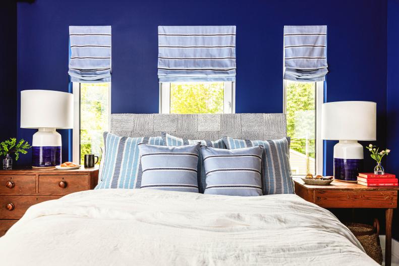 Blue Bedroom With Three Windows That Fill Space With Natural Light