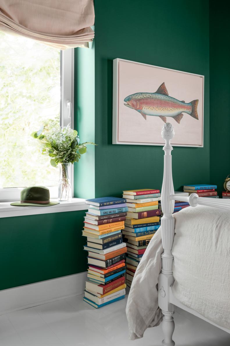 Tall Stacks of Books Add Color to Green Guest Bedroom