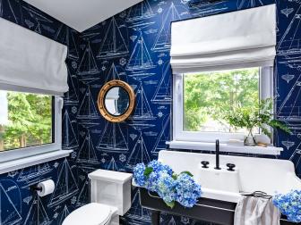 Blue Nautical-Themed Bathroom With White Floor and Skylight