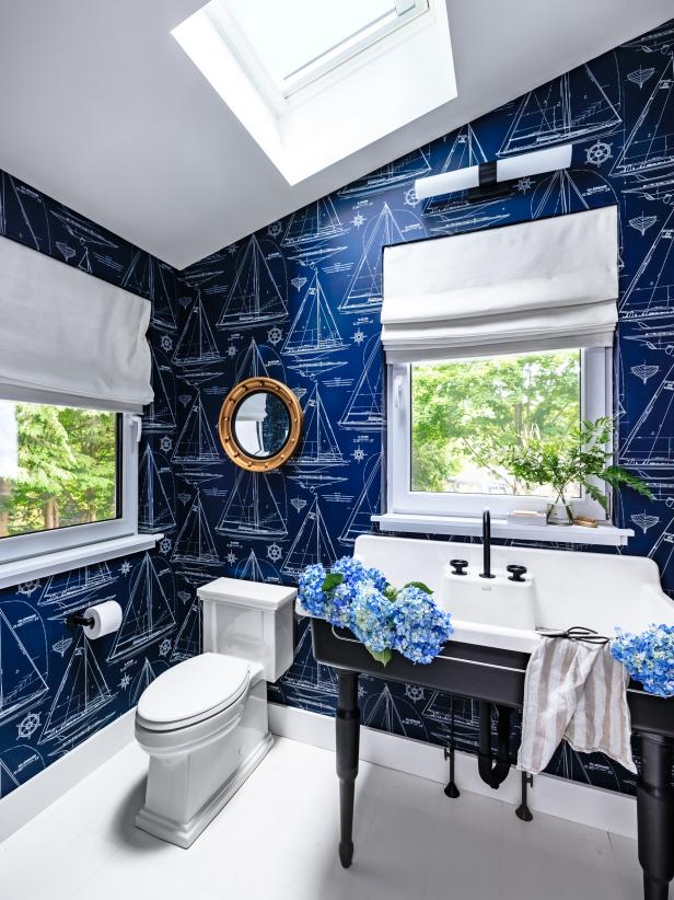 Blue Bathroom Features Skylight and Nautical-Themed Wallpaper