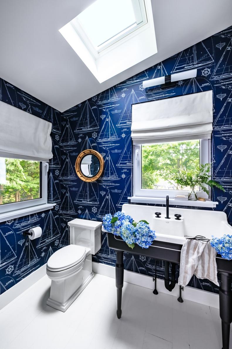 Blue Bathroom Features Skylight and Nautical-Themed Wallpaper