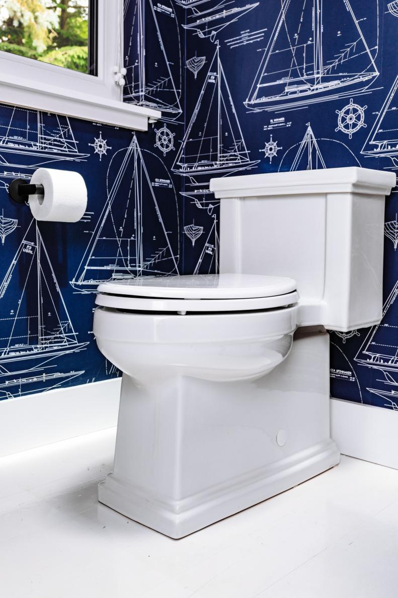 White Toilet With Architectural-Style Molding in Blue Bathroom