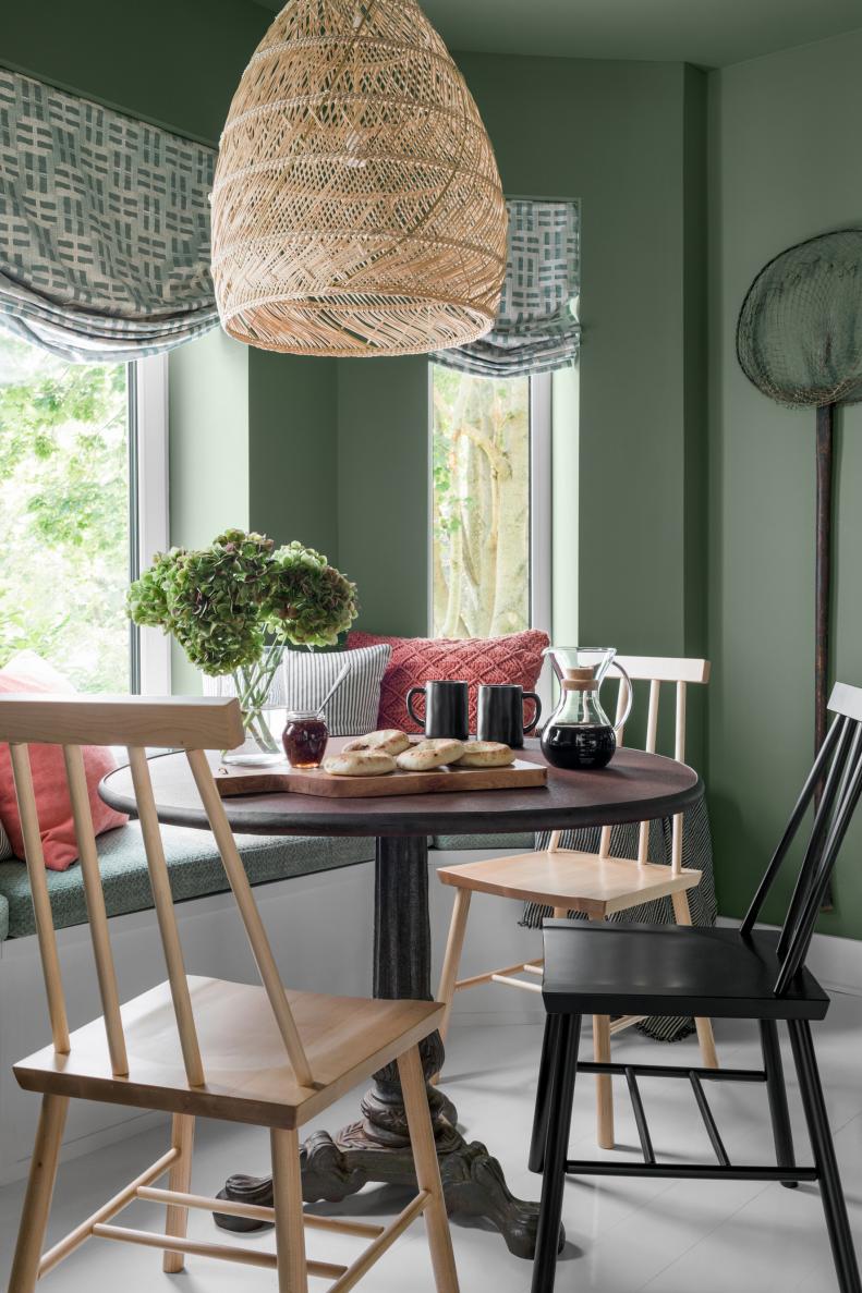 Wood Chairs Around Round Table in Breakfast Nook With Banquette
