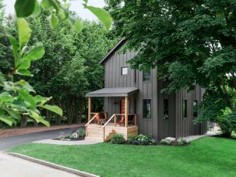 Wide View Showcases Home's Front Exterior, Lush Lawn and Wood Porch