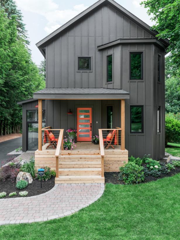 Dark-Gray Home With Bright Orange Front Door and Natural-Wood Porch