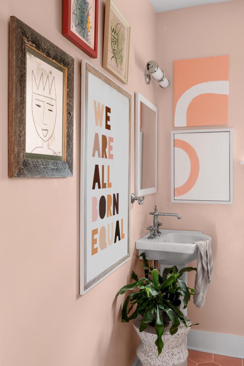 Collection of Framed Art on Walls in Pink Guest Bathroom