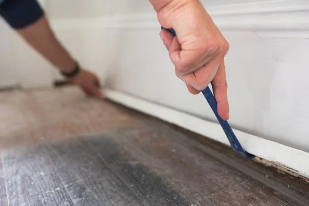 Use a pry bar to gently remove base molding