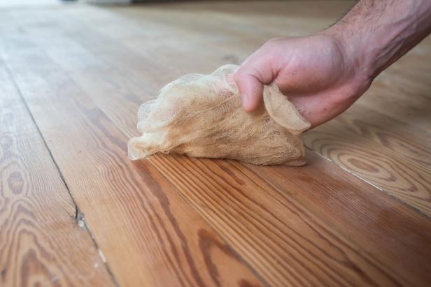 Use a sticky tack cloth to remove any particles on the wood floor.