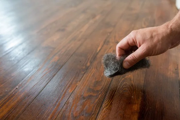 Between coats of polyurethane, let the product dry completely (refer to manufacturer’s instructions for drying times) and buff the floor between each coat with a machine buffer or by hand with a #2 fine steel wool pad.