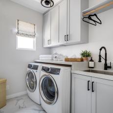 Contemporary White Laundry Room With Black Hardware and Pendant 