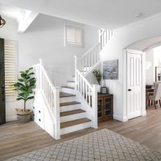 Contemporary Coastal Entryway With Staircase and Neutral Area Rug 