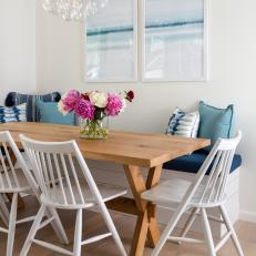 Blue and White Coastal Dining Area With Bubble Chandelier