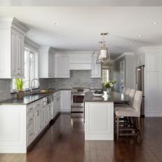 Gray and White Open Plan Kitchen With Dark Wood Floor
