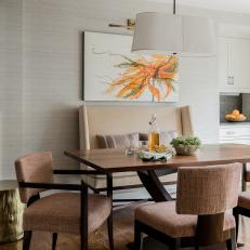 Brown Transitional Dining Area With Orange Art