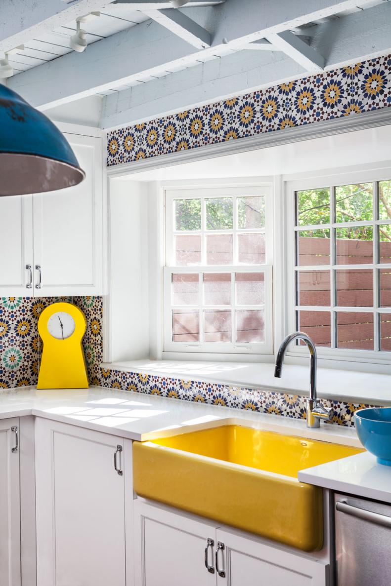 This bright kitchen features a yellow sink and Moroccan tile.