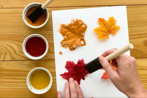 Paint the faux fall leaves with autumn-inspired colors like gold, red, orange and yellow.