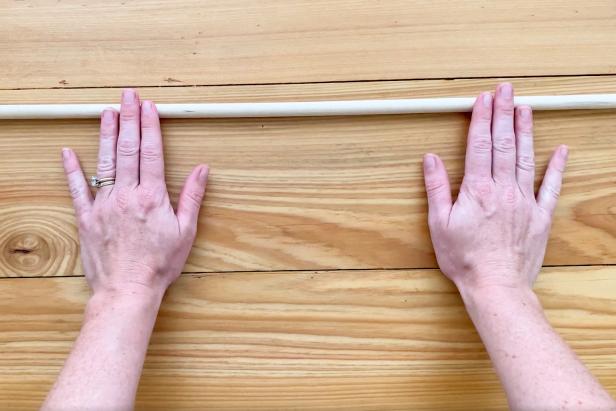 Use a 2-1/2 ft long dowel rod as the base. Now determine how many strands to place on the dowel rod.