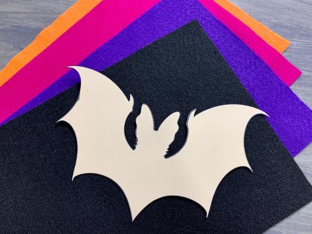 Search for a simple free bat image online. Print onto a piece of cardstock and carefully cut out the image to use as a template. Keep it simple with easy shapes. TIP: Choose an image without a lot of detail or sketch a bat from freehand!
