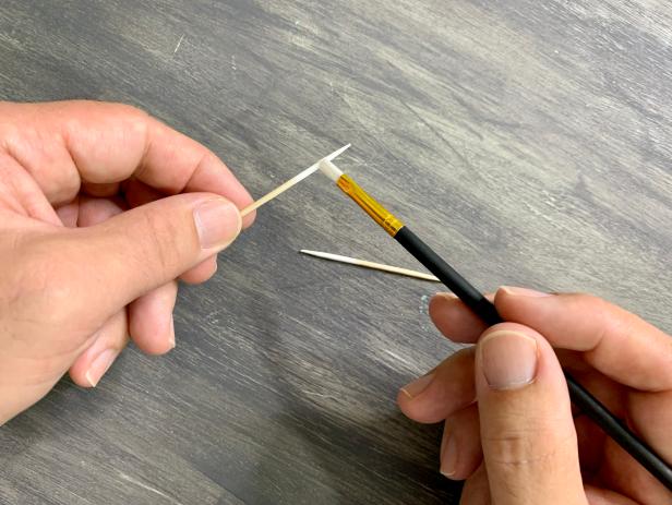Paint the ends of two toothpicks with white acrylic paint for the teeth. Once dry, snip off the tip using a pair of wire cutters.