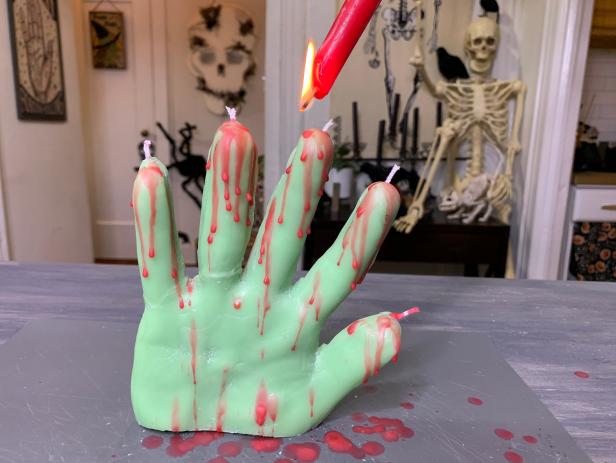 Use a wax pen to draw ghost-like facial features or add a bloody drip effect by lighting a red candle and dripping the wax over your candle.