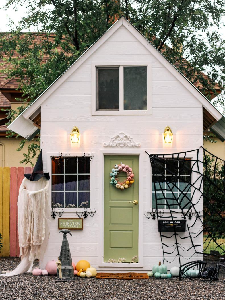 Cobwebs and a ghost standing guard give this otherwise pretty playhouse by At Home With Ashley a spooky touch. (Yes, the skeleton arm's fingers are crossed for good luck). 