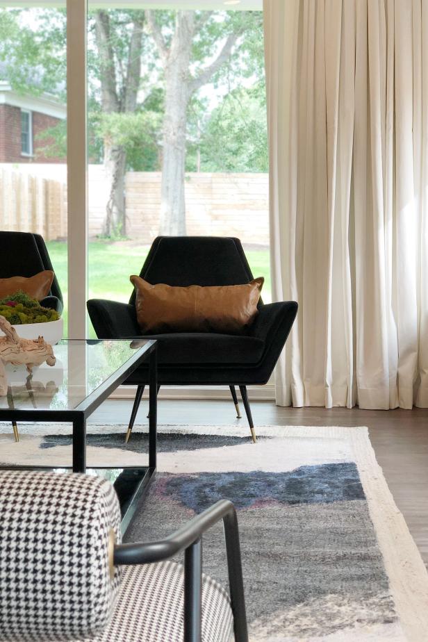 Black Side Chairs With Brown Leather Cushions In A Living Room Design