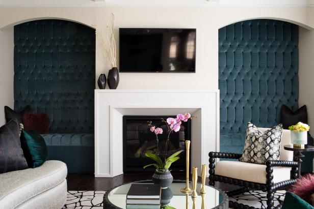 Blue Tufted Benches Flank A White Fireplace In This Living Room Design