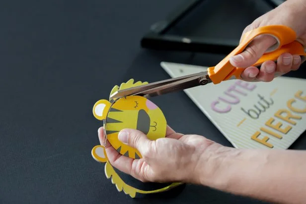 Use scissors to cut the lion chipboard into a more modern circle.