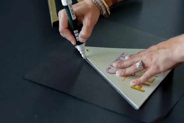 Trace the triangular shape onto the card stock with a chalk marker. Then cut out the shape with scissors.