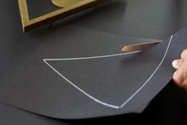 Use the art backing as a template. Now, trace and cut out the triangle shape.
