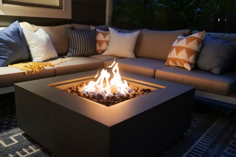 Summertime calls for s'mores and ghost stories. Give your family a good excuse to gather 'round by making a fire pit the focal point of your sitting area — and pay close attention to the shape of the feature. A square fire pit like this, with its clean lines and sharp edges, will fit neatly against a sectional and lend a sleek touch to the space, while something circular will generally soften the setting and make it feel a bit more intimate.