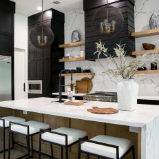 Black and White Modern Chef Kitchen With White Stools