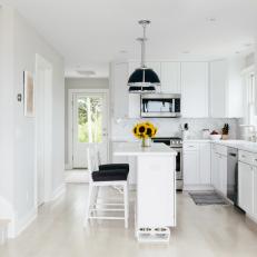 White Open Plan Kitchen With Sunflowers