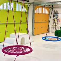 Multicolored Garage Playroom With Swings
