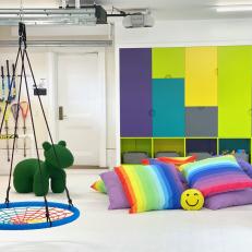 Multicolored Garage Playroom With Rainbow Pillows