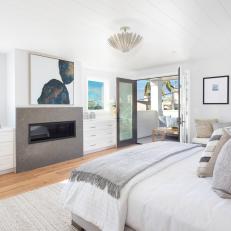 Coastal Bedroom With Gray Fireplace